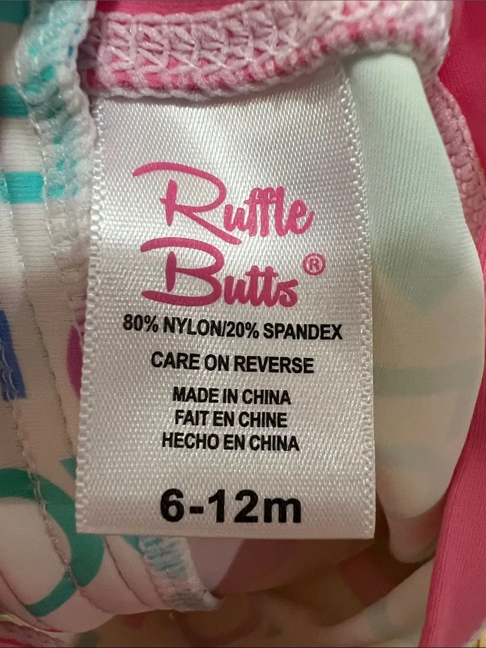 Ruffle Butts pink Love print ruffle bottom one piece rash guard swim-flaw